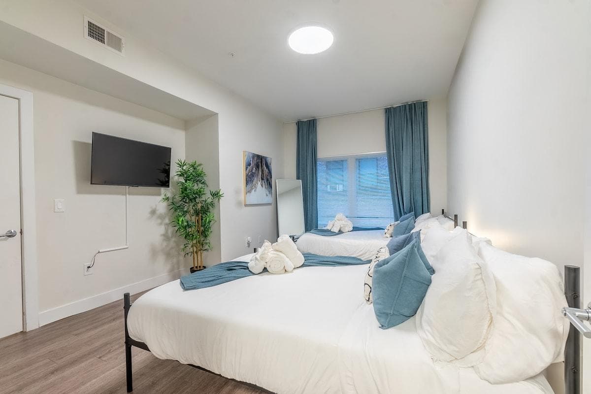 Your guest will enjoy watching TV while laying in one of 2 Queen-size beds in the bedroom.